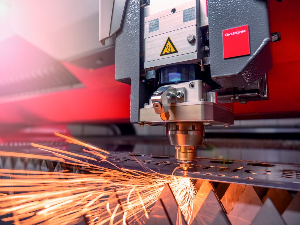 Fiber laser cutting machine cutting steel sheet with sparks